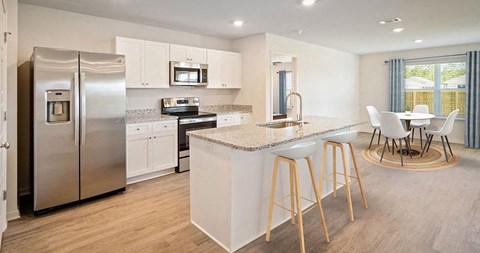 a kitchen with a counter top and a stainless steel refrigerator