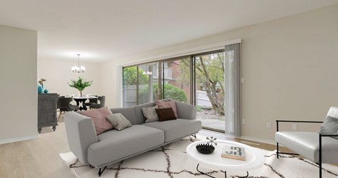 A living room with a grey couch and a coffee table.