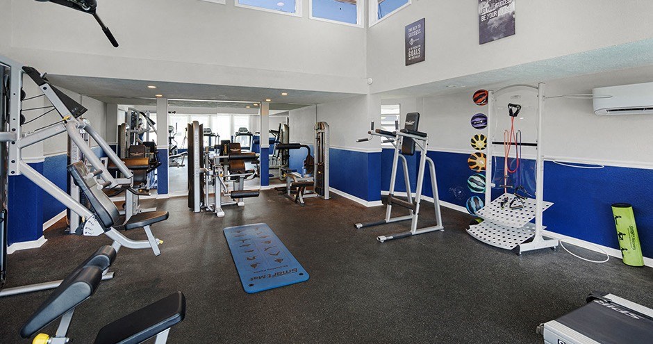 a gym with a lot of exercise equipment