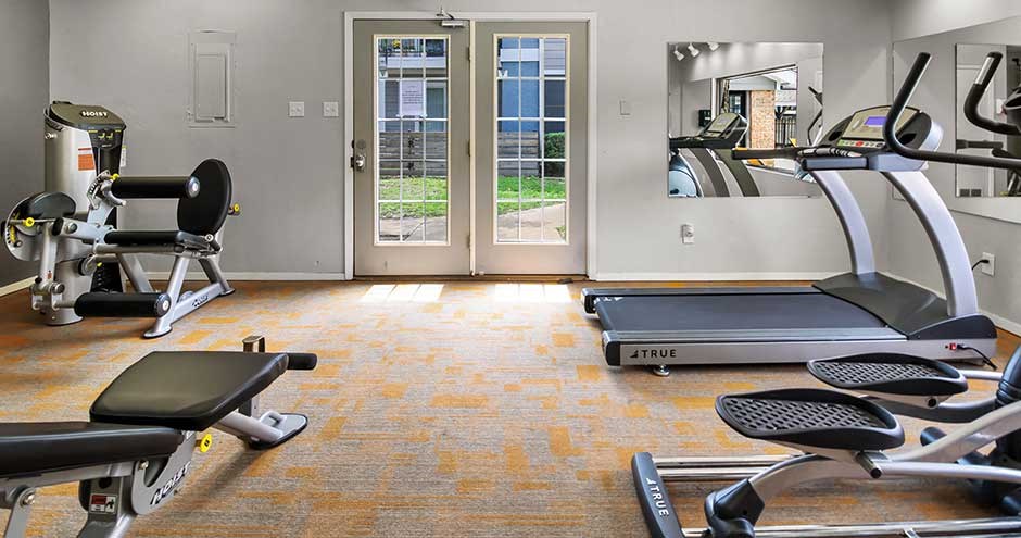 a room filled with exercise equipment and a mirror