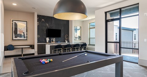 A pool table with balls set up in the middle of it.