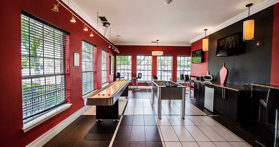 a large room with a ping pong table and a television
