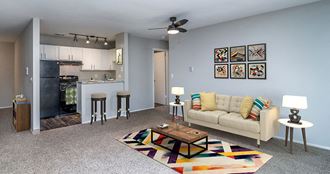 a living room and kitchen with a couch and a table