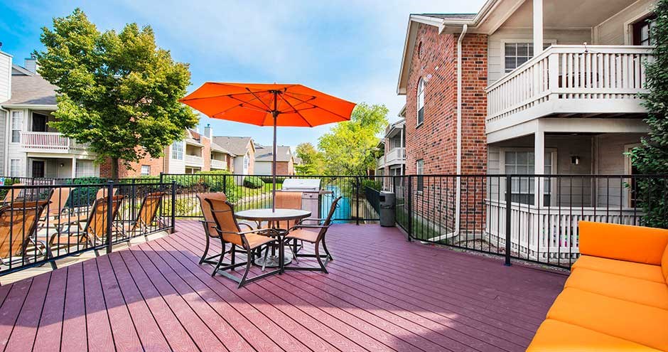 a patio with a table and chairs and an umbrella