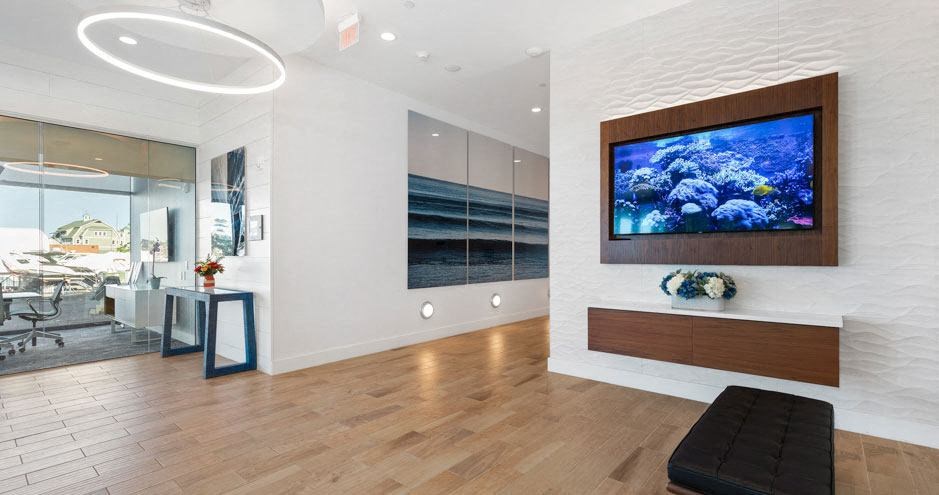 a living room with a fish tank on the wall