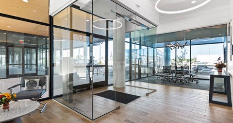a conference room with glass walls and a table and chairs