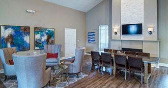 a living room with a table and chairs and a television