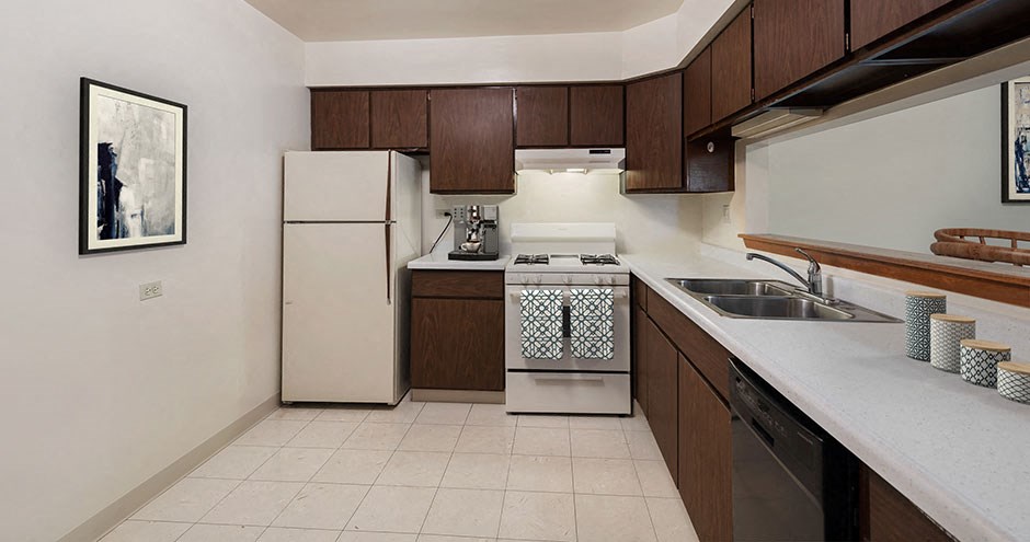 a kitchen with a stove refrigerator and a sink