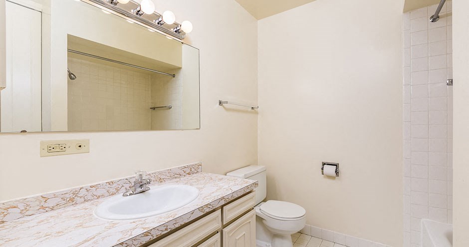 a bathroom with a sink toilet and a mirror