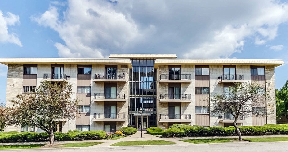 an apartment building with balconies on a cloudy day