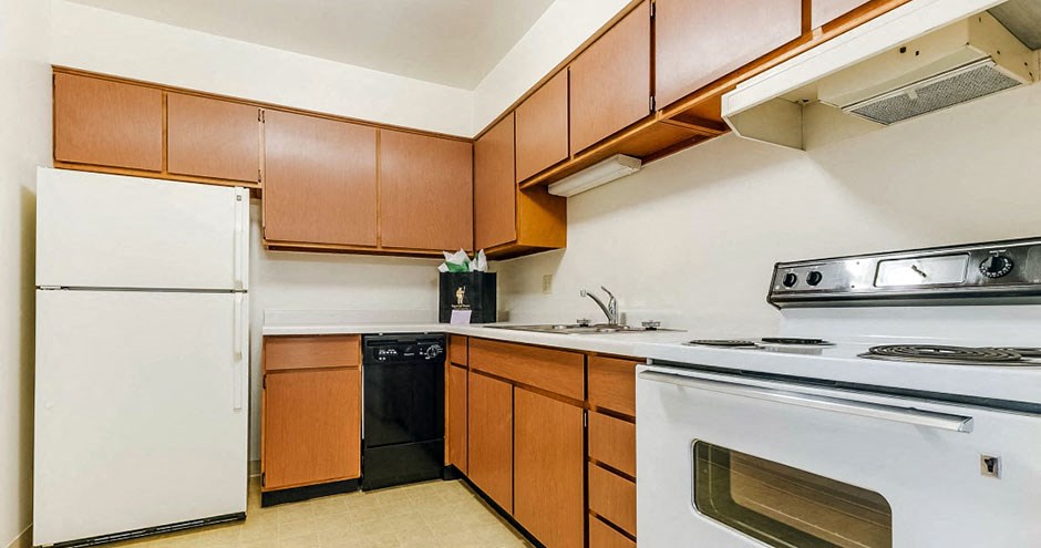 a kitchen with white appliances and wooden cabinets