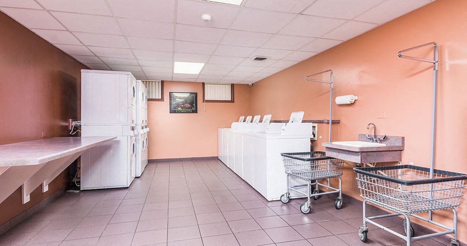 a kitchen with two refrigerators and a counter and a shopping cart