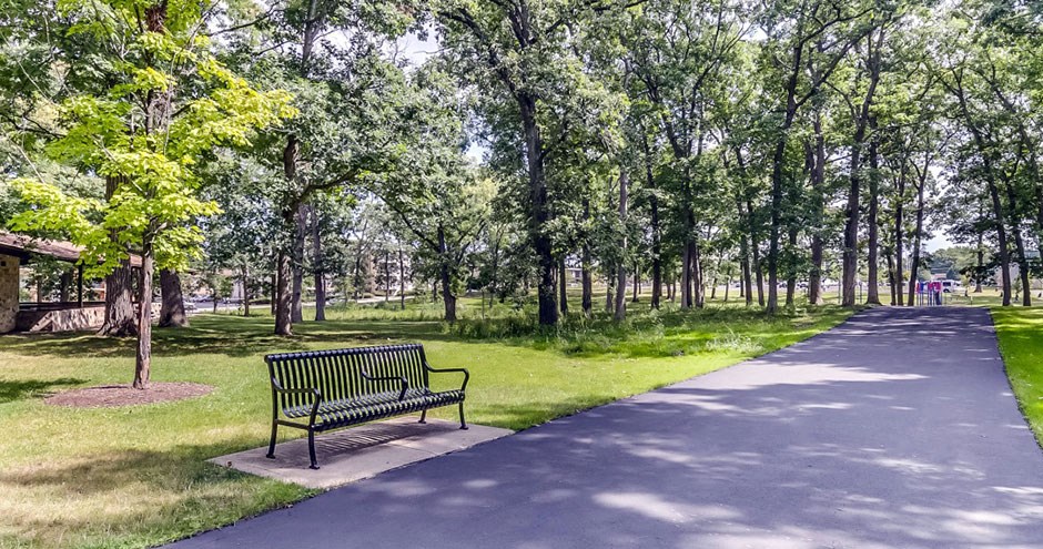 a park bench sitting next to a path