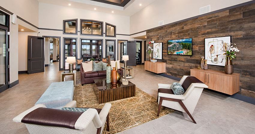 a living room with couches and chairs and a television