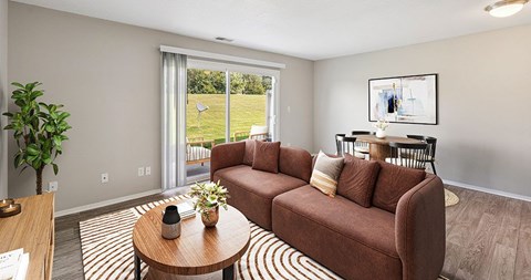 A living room with a brown couch and a coffee table.