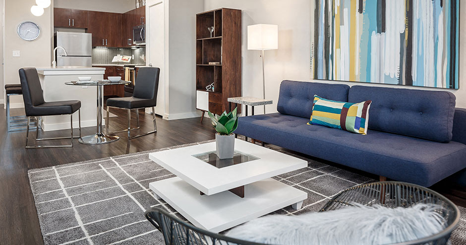 a living room with a blue couch and a table
