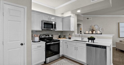 a kitchen with a stove and a sink and a microwave