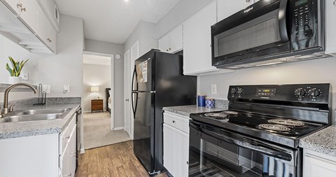 A black refrigerator is in the kitchen.