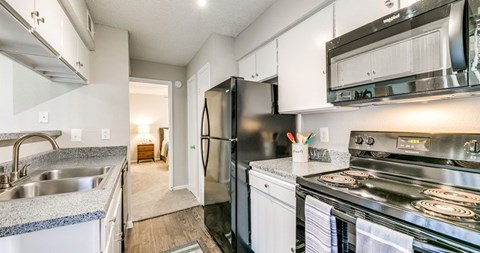A kitchen with a stainless steel refrigerator and oven.