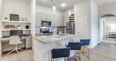 a kitchen with a bar and chairs