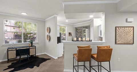 a living room with a bar and two chairs