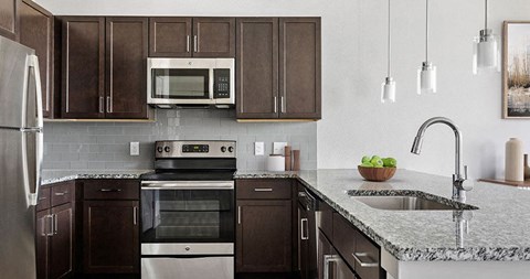 a kitchen with a sink and a stove and a microwave