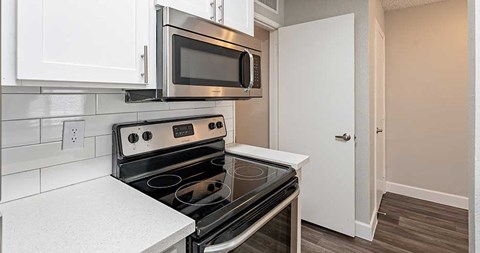 a kitchen with a stove and a microwave