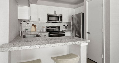 a kitchen with a counter top and a refrigerator