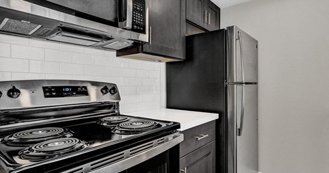 a kitchen with a stove and a refrigerator