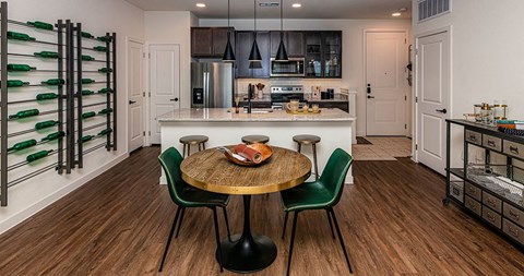 A kitchen with a table and chairs in the middle of the room.