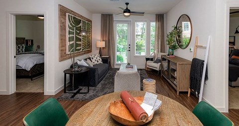 A living room with a green chair and a wooden table.