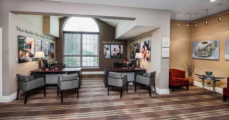 a lobby with chairs and tables and a couch