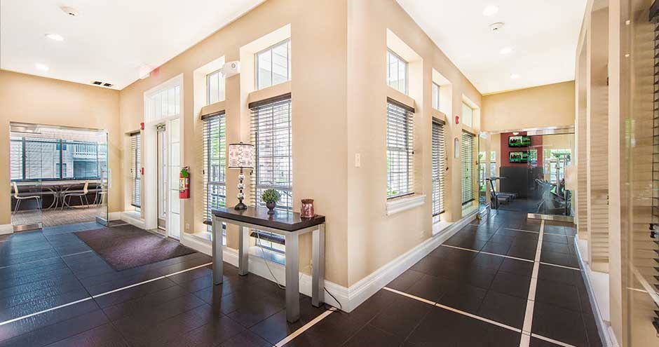 a hallway with a table and a table with a plant on it