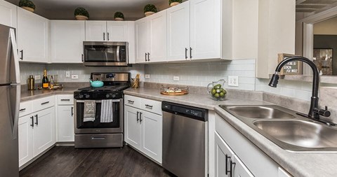 a kitchen with stainless steel appliances and white cabinets