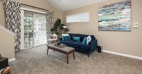 a living room with a blue couch and a table