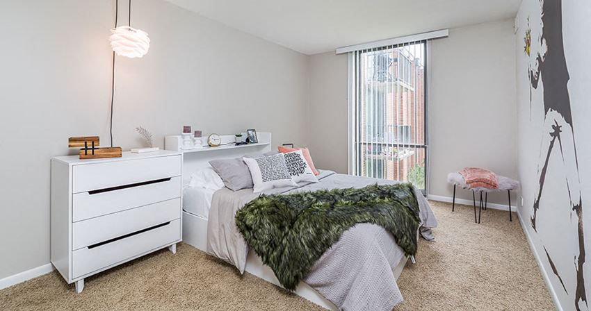 a bedroom with a bed and a dresser