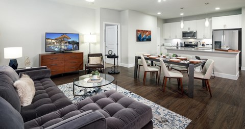 A modern living room with a grey sofa and a coffee table.