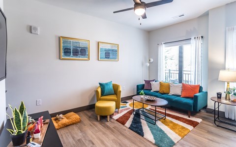 A living room with a yellow chair and a blue couch.