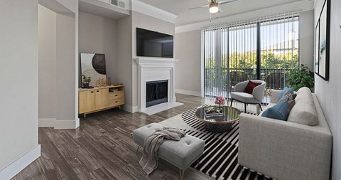 A living room with a grey couch and a wooden coffee table.