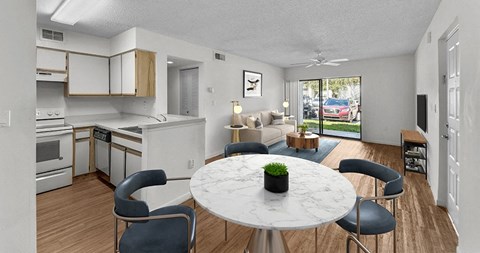 an open kitchen and living room with a table and chairs