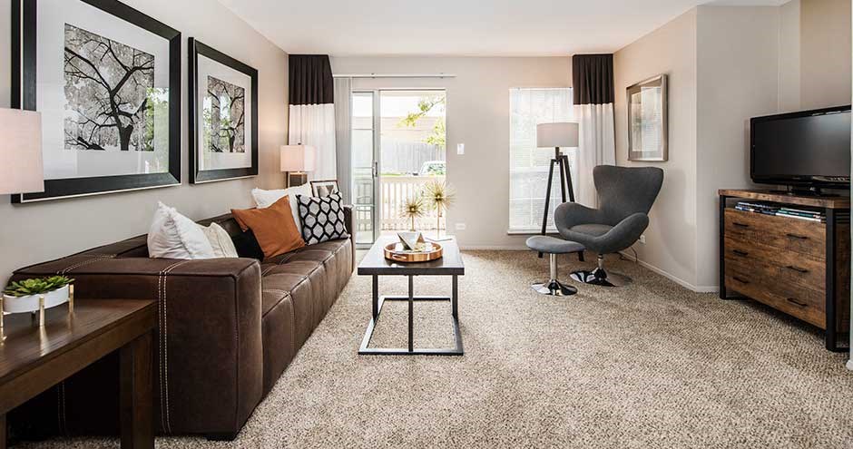 a living room filled with furniture and a flat screen tv