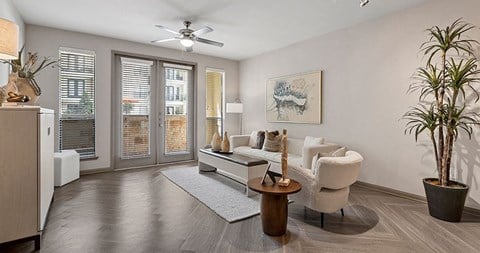 a living room with a couch and a ceiling fan