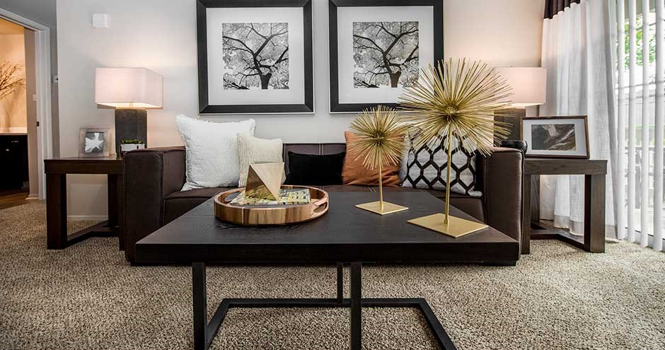 a living room filled with furniture and pictures on the wall