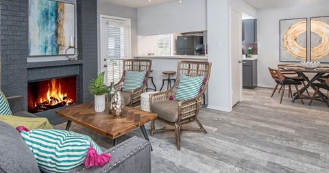 A living room with a fireplace and a painting on the wall.
