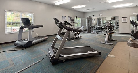 a gym with various exercise equipment in a building