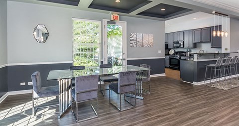 a dining room and kitchen with a glass table and chairs