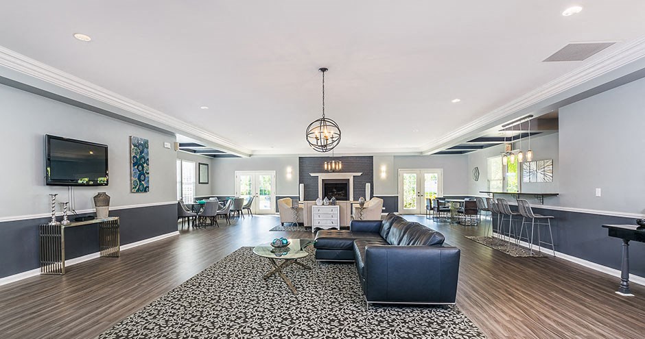 a living room with leather furniture and a fireplace