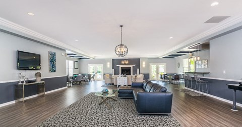 a living room with leather furniture and a fireplace