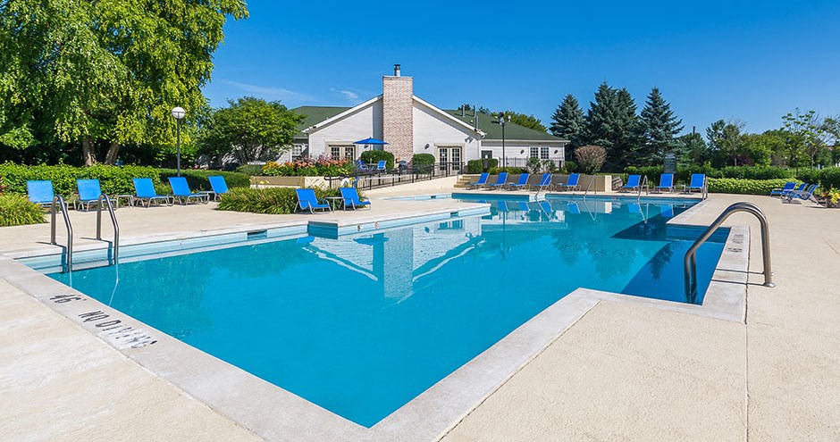 the swimming pool at our apartments with chairs around it