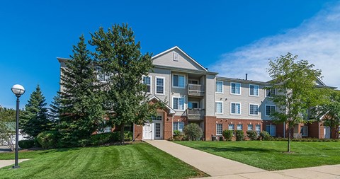 an apartment building with a sidewalk in front of it